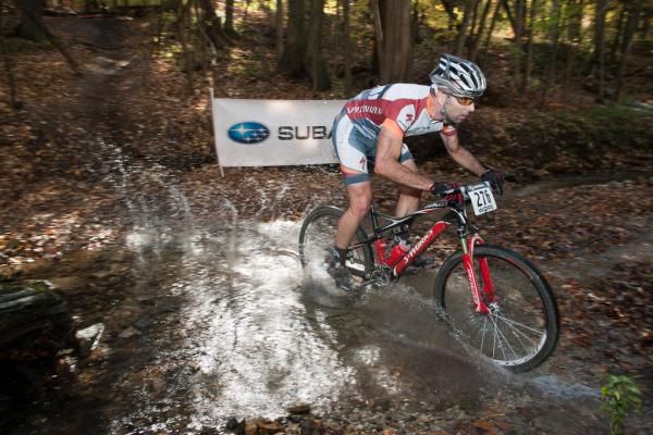 WORS Wigwam MTB Challenge winner Mike Phillips (Adventure 212 / Specialized) crosses a stream at the Sheboygan course.