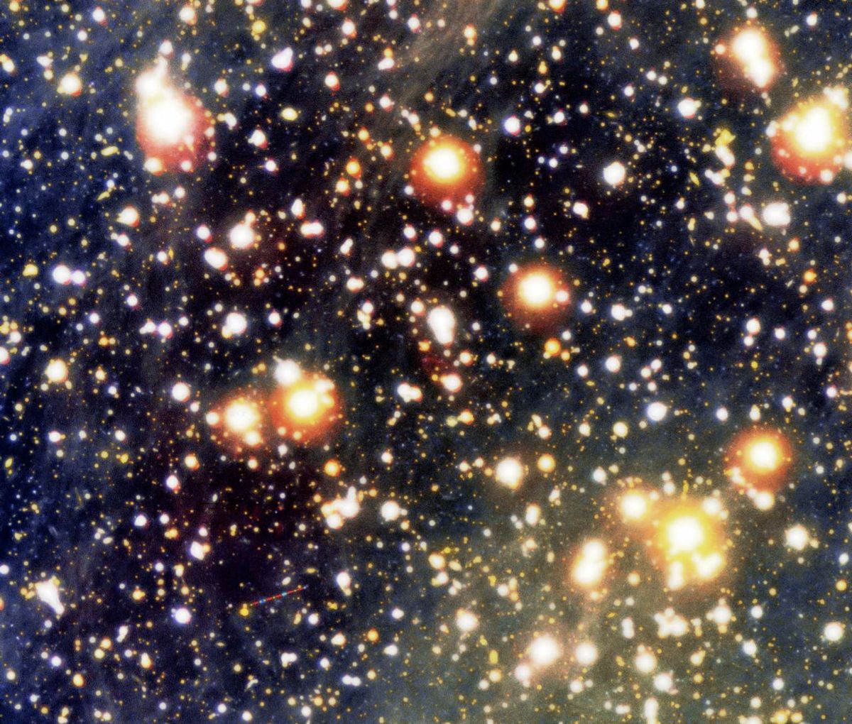 This Very Large Telescope image is a color composite view of the the sky field around the neutron star RX J1856.5-3754 (in the exact center of image) and the related cone-shaped nebula. The trail of an asteroid is seen in the field with intermittent blue,