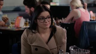 Ariel Winter sitting at a table on Modern Family