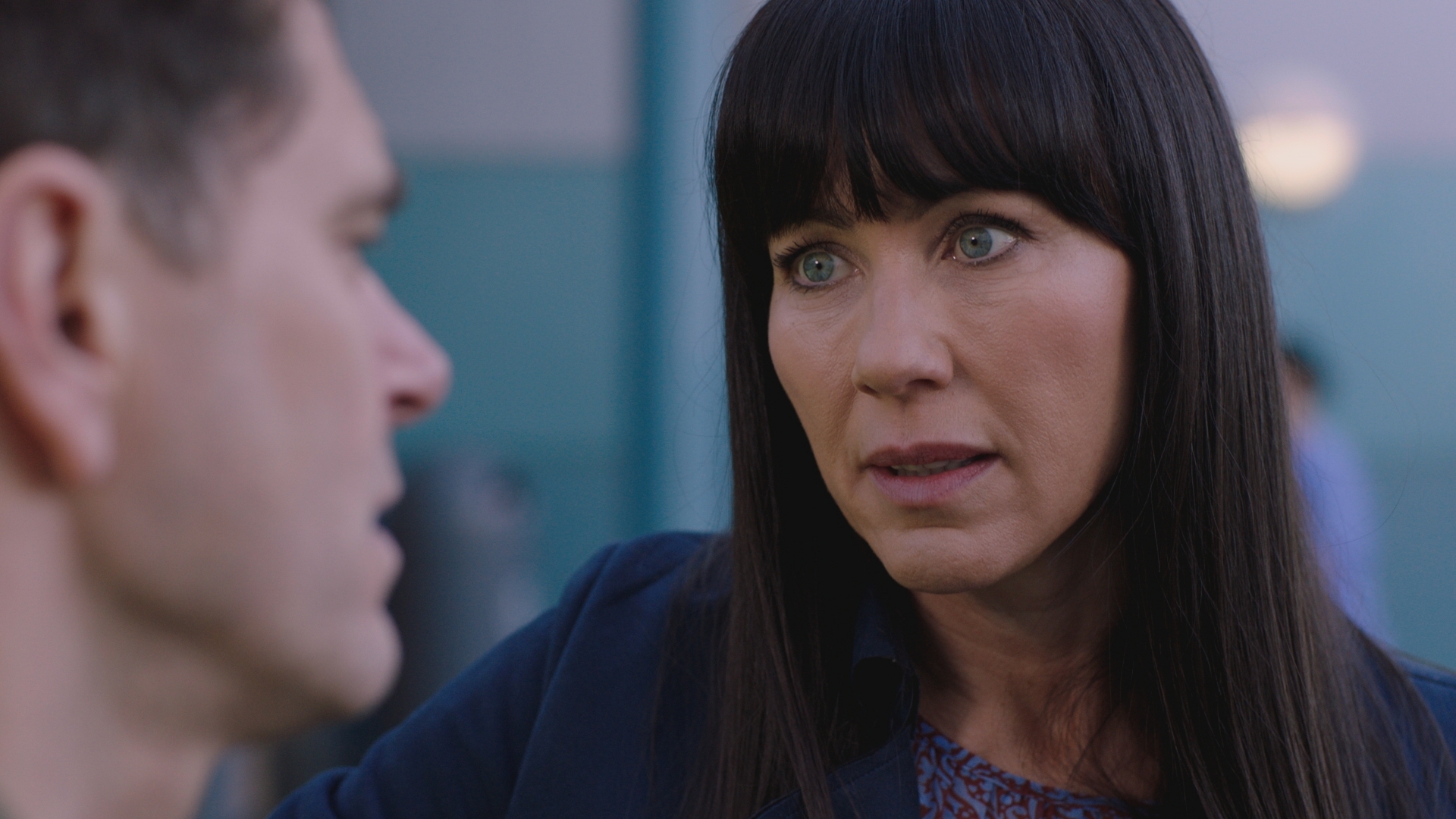 Looking concerned Faith talks to Iain outside Holby ED after their shifts have ended.