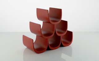 'Noè' wine rack by Giulio Iachetti for Alessi. Three rows of half circle red wine holders in the shape of a triangle.
