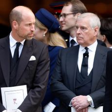Prince William and ex-Prince Andrew both wear black suits with white shirts and black ties while attending a royal funeral at Westminster Cathedral