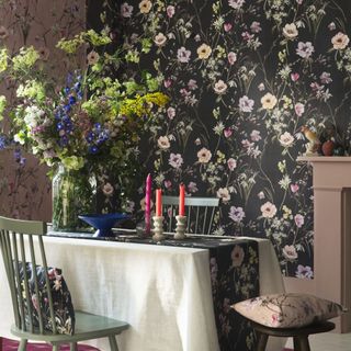 floral wallpapered dining room with table and chairs