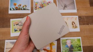 The Fujifilm Instax Link Wide 2 photo printer on a bookshelf