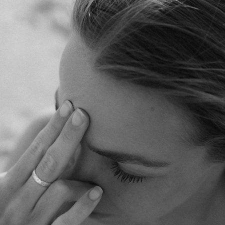 A woman tapping her head with two fingers; two nature images.