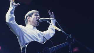 Paul Simon performing live on stage in a scene from new documentary biopic 'In Restless Dreams: The Music of Paul Simon'