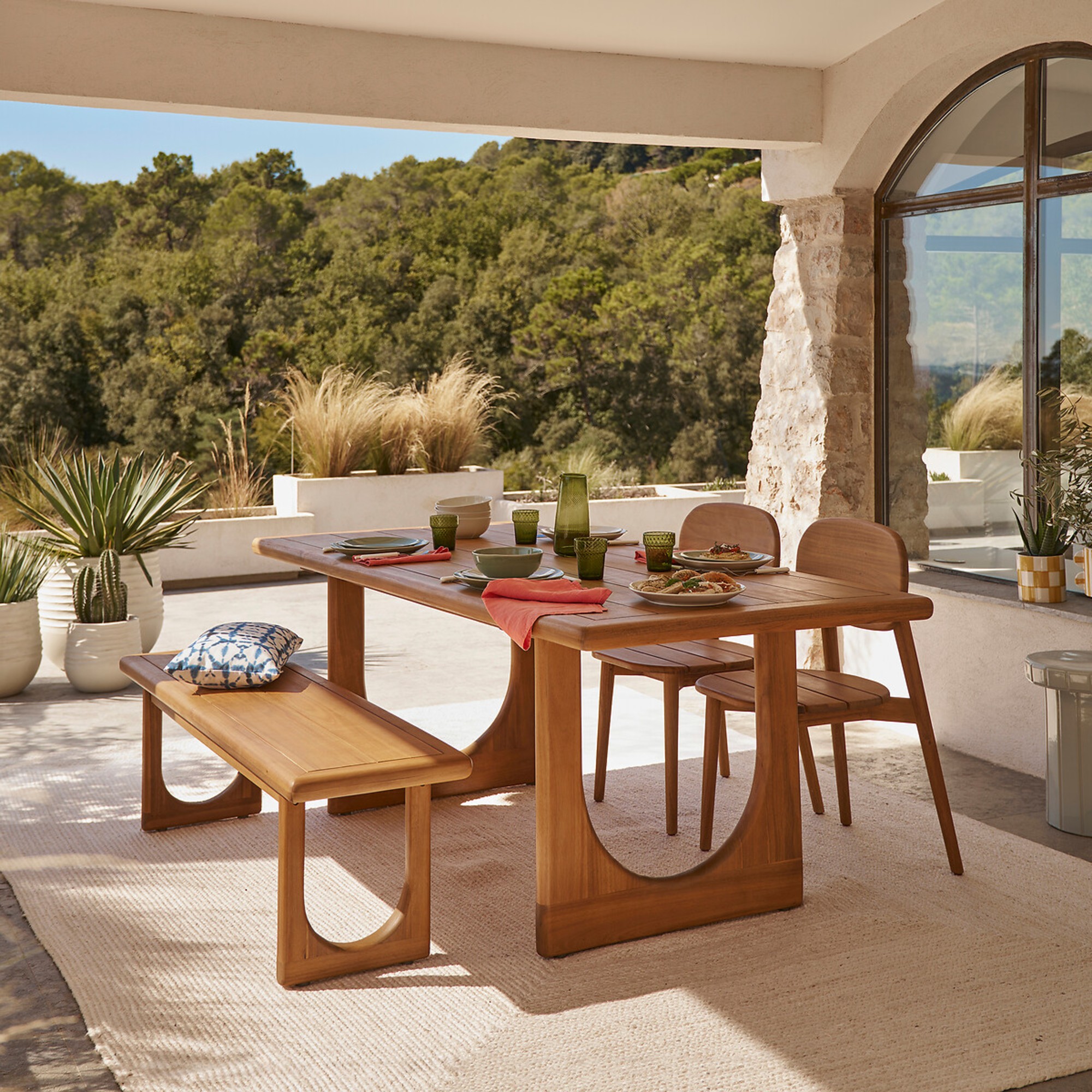 La Redoute Douve 6 To 8-Seater Garden Table in Solid Acacia with a matching bench and chairs on a Mediterranean patio