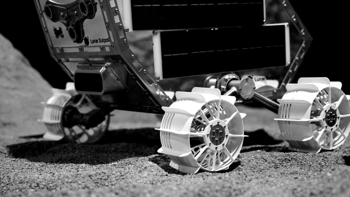 close-up artist&#039;s illustration of a small, white-wheeled rover on the moon