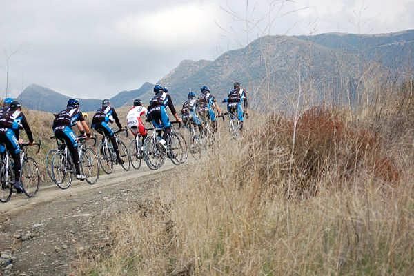 The riders enjoy some dirt road climbing before the rain hits.
