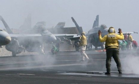 Crewmen aboard a U.S. military flotilla stationed in Bahrain, the tiny island which serves as a Middle East anchor for U.S. military strategy.