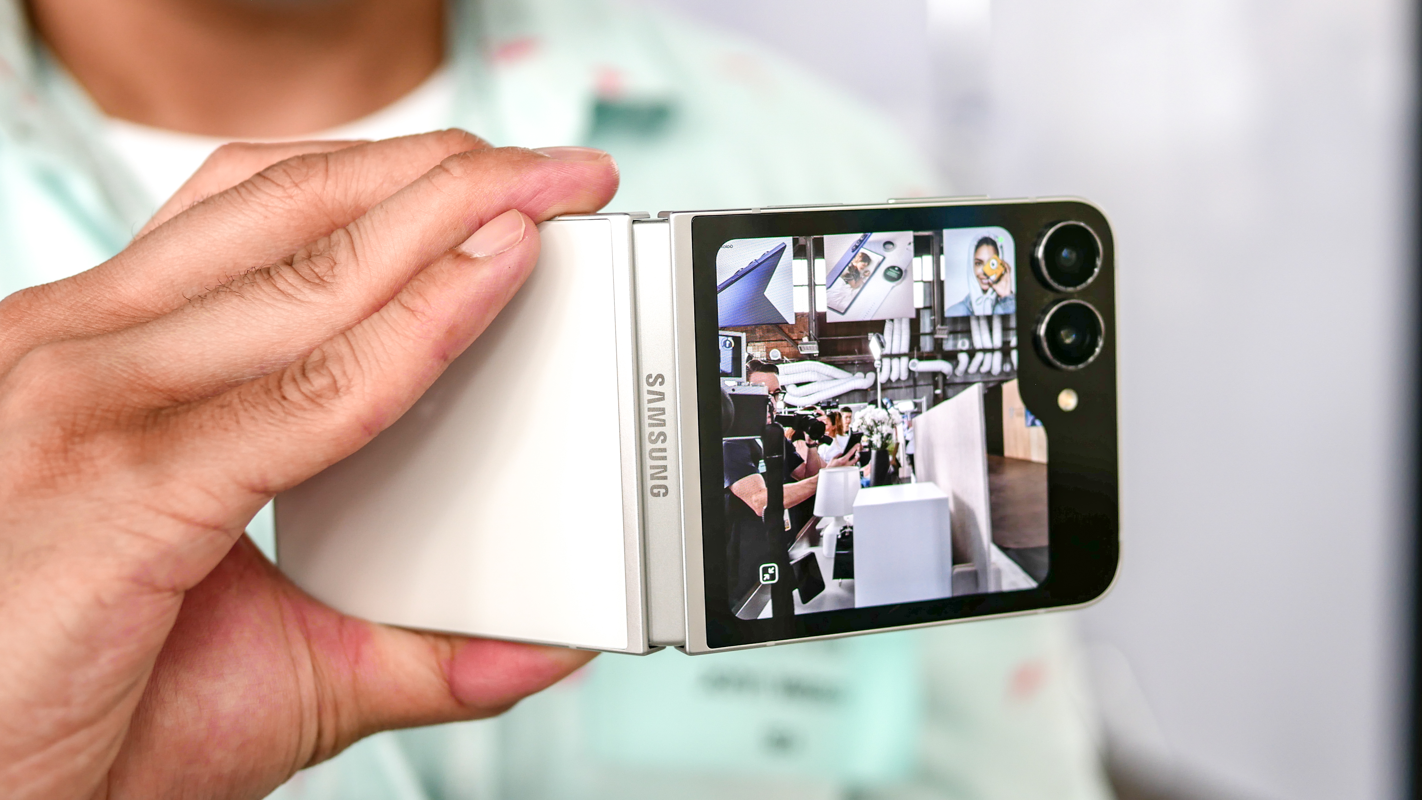 Samsung Galaxy Z Flip 7 FE held in the hand with Flex Mode.