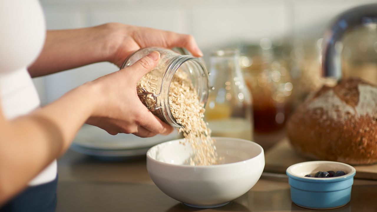 Woman pouring oats into a bowl