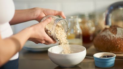 Woman pouring oats