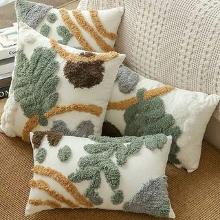 Tufted boho throw pillows in green leaf designs