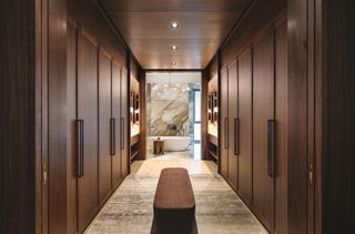 bespoke cabinetry in walk in wardrobe at Brewin apartment by Robert Cheng