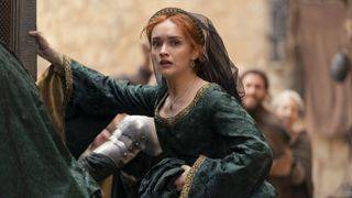 Queen Alicent Hightower (Olivia Cooke) looks flustered in a green and gold dress in House of the Dragon season 2