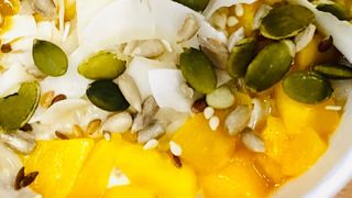 Bowl of porridge with coconut and mango