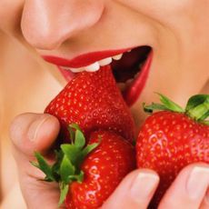 woman eating strawberries