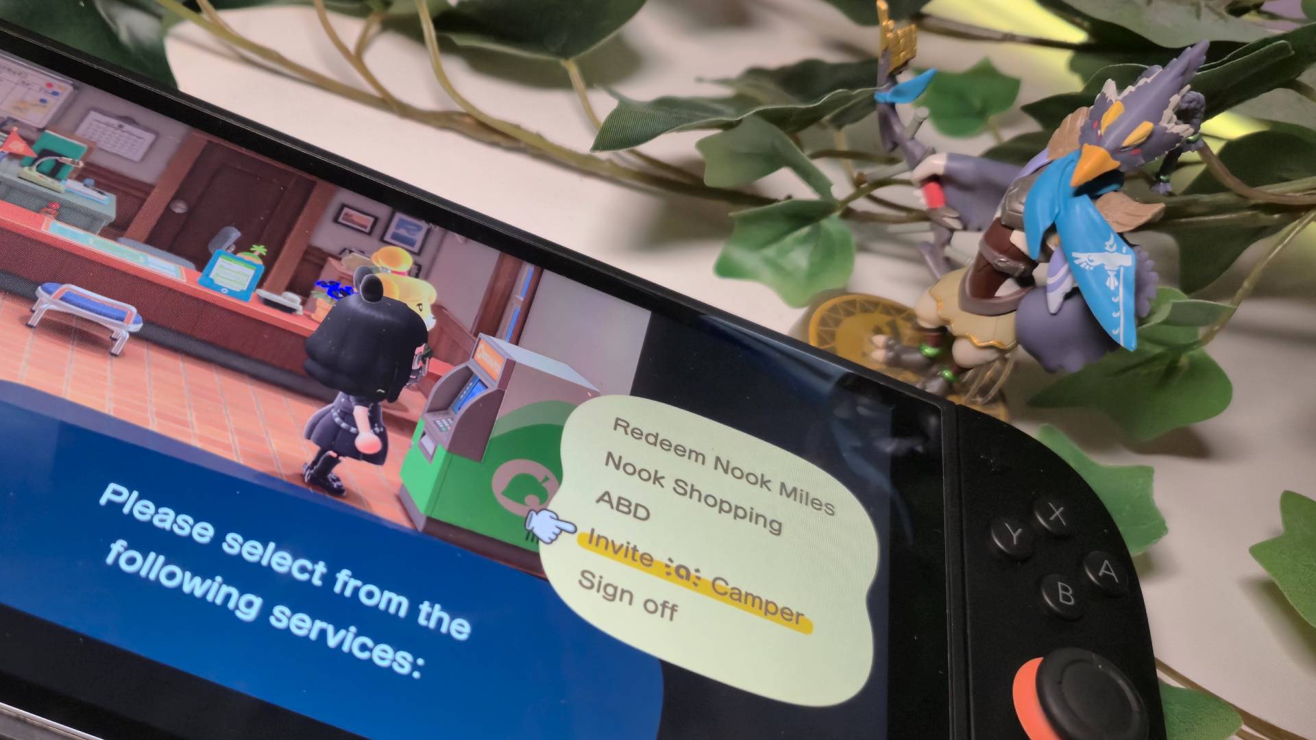 Photo showing the Revali amiibo sitting next to the right side of a Nintendo Switch 2 that's running Animal Crossing New Horizons.