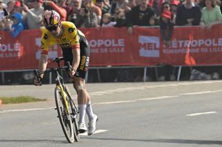 Wout van Aert dismounts his bicycle after his mechanical failure in the closing kilometres of Paris-Roubaix 2023