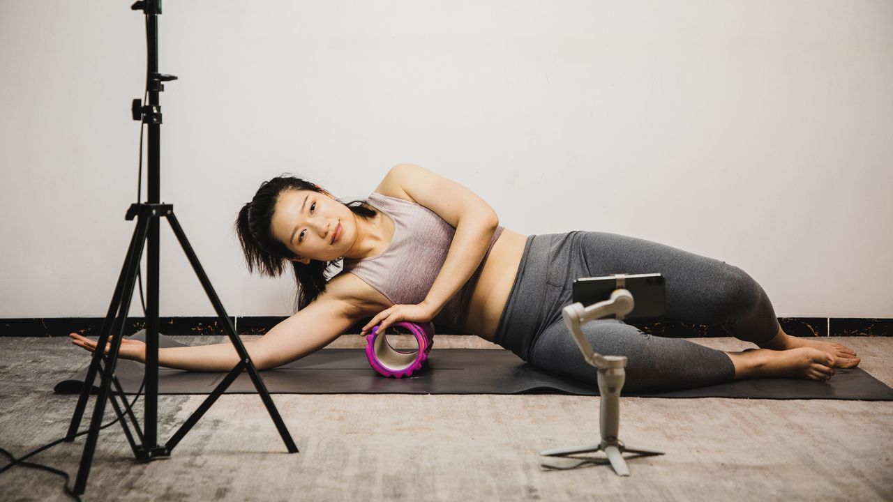 Instagram model capturing herself using a foam roller