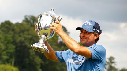 Kevin Kisner celebrates with the trophy after winning the 2021 Wyndham Championship