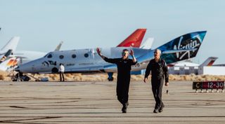Mark Stucky (left) and C.J. Sturckow walk away from SpaceShipTwo after landing the suborbital spaceplane Dec. 13. The two will receive FAA commercial astronaut wings for flying to an altitude above 80 kilometers.
