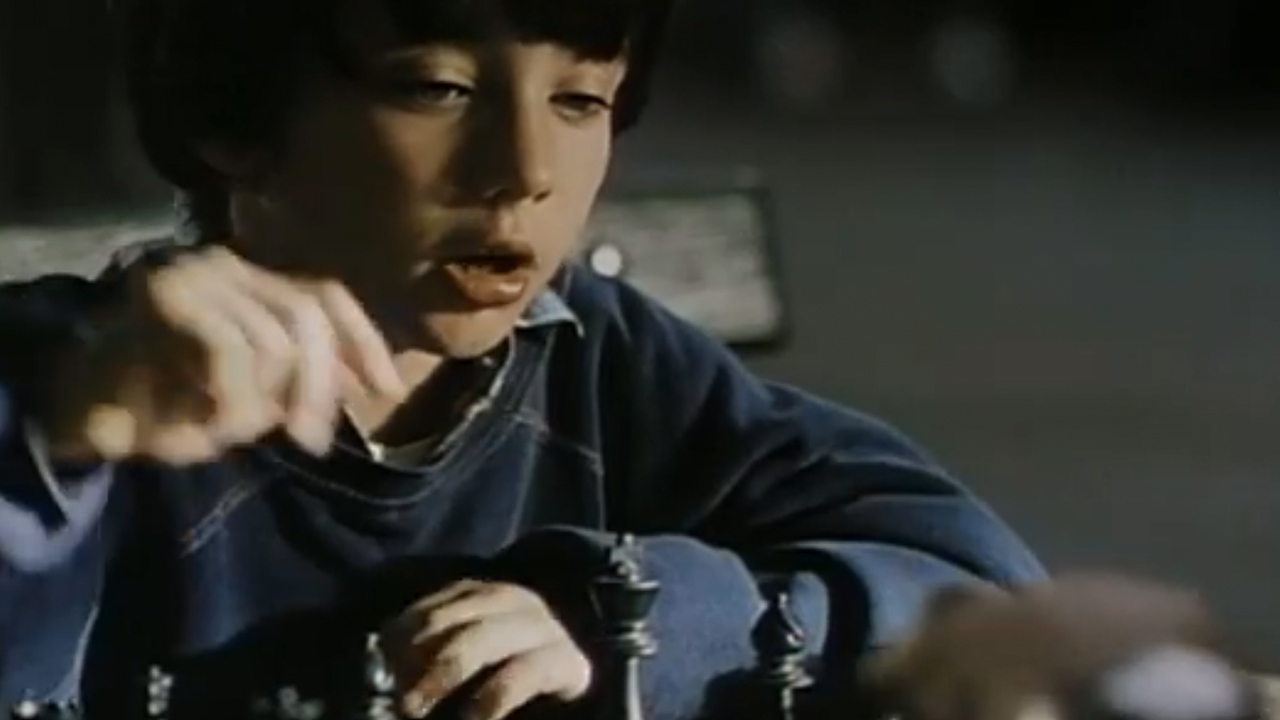 A young boy making a move in chess in Searching For Bobby Fischer