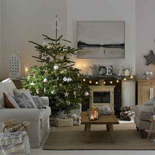living room with christmas tree decorated with white ornaments