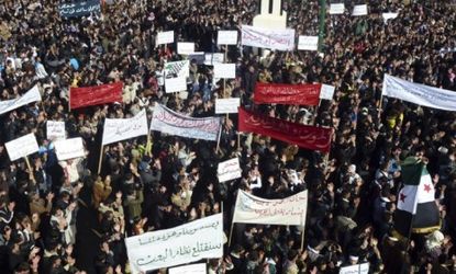 Demonstrators protest near Homs: Syrian forces resumed their bombardment of the city of Homs Monday after Arab countries called for U.N. peacekeepers. 