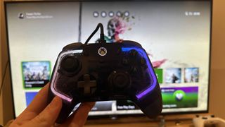 GameSir Kaleid review image of the controller in front of a TV displaying the Xbox