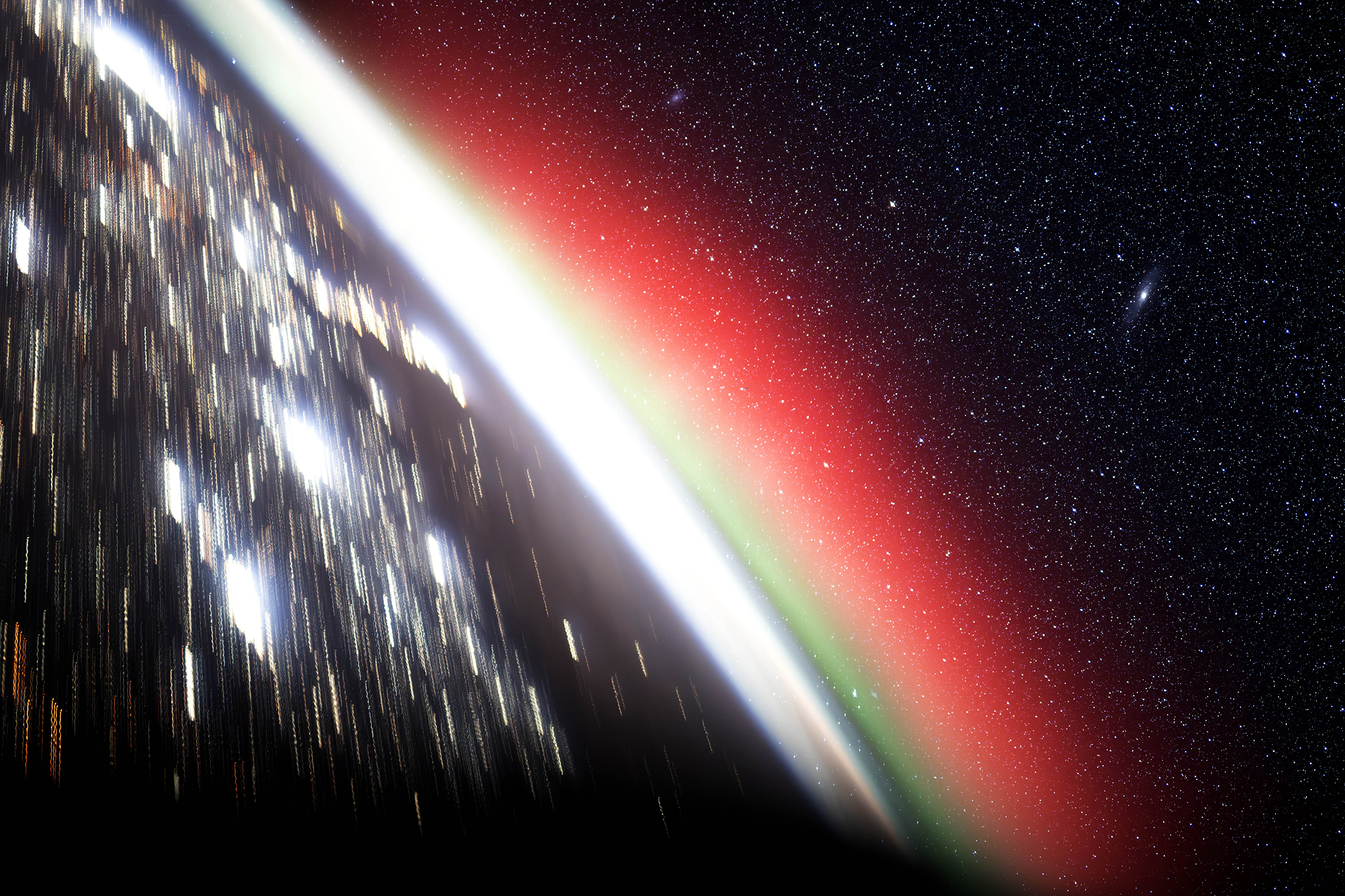 A stunning image of Earth from space showing city lights, a vibrant red and green atmospheric glow, and a star-filled sky. The scene conveys awe and wonder