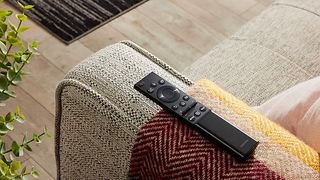 Samsung TV remote on sofa arm