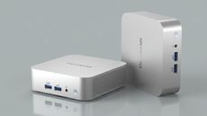 Geekom A6 mini PC on a grey background
