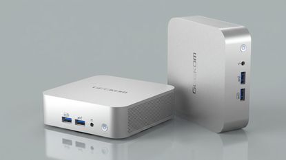 Geekom A6 mini PC on a grey background