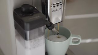 The De'Longhi Rivelia making a latte using almond milk