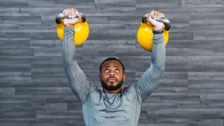 Man lifting two kettlebells