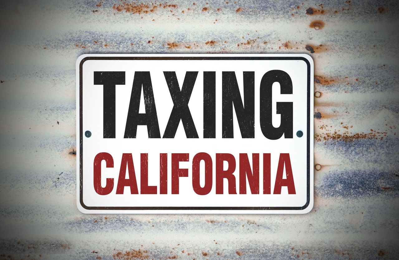 Metal sign that says TAXING CALIFORNIA