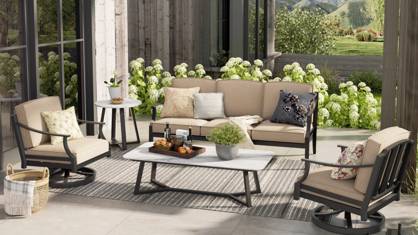 an outdoor living room with outdoor furniture with tan cushions and black frames