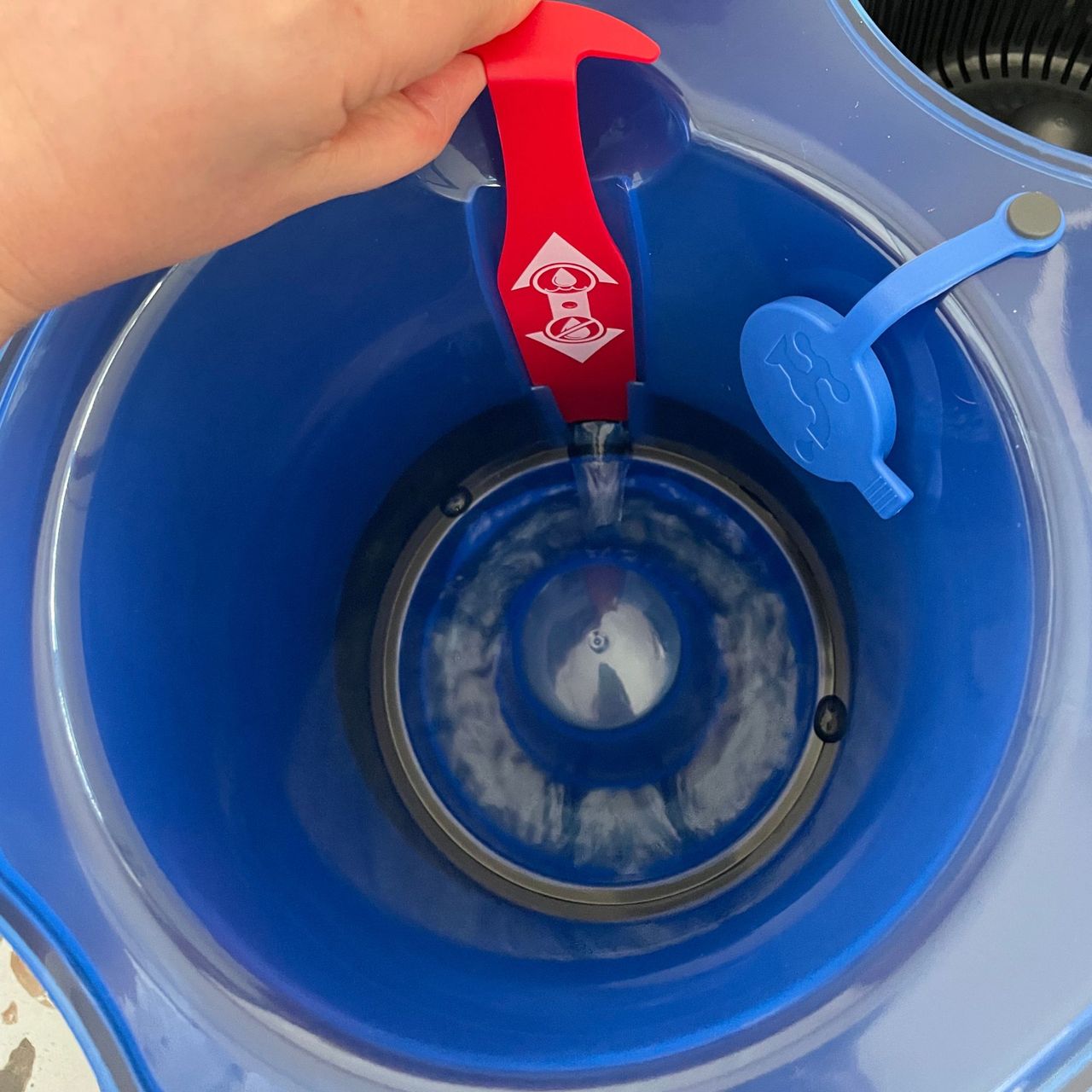 Filling the Vileda RinseClean Spin Mop &amp; Bucket System water canister with water
