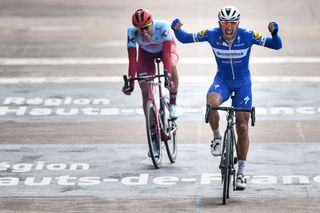 Belgian Philippe Gilbert of Deceuninck QuickStep celebrates as he crosses the finish line to win before German Nils Politt of KatushaAlpecin L the sprint at the finish of the 117th edition of the ParisRoubaix one day cycling race from Compiegne near Paris to Roubaix Sunday 14 April 2019 BELGA PHOTO DAVID STOCKMAN Photo credit should read DAVID STOCKMANAFP via Getty Images