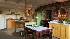 Cottage kitchen diner with exposed brick and yellow cabinets