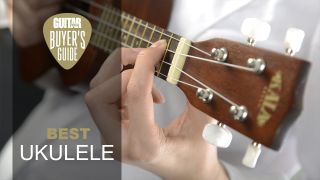 Close-up of fingers on the fretboard of a ukulele
