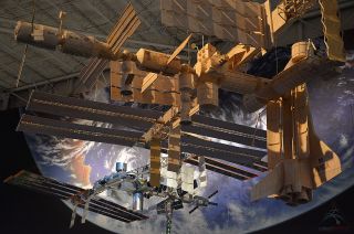 — Ripley's Believe It or Not! matchstick model of the International Space Station is suspended in front of Space Center Houston's other scale replica of the orbiting outpost.