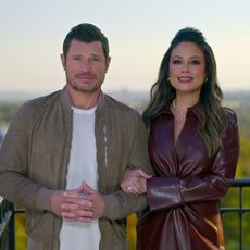 Nick and Vanessa Lachey stand on a balcony in front of the White House and Washington Monument, in 'Love is Blind' season 7.