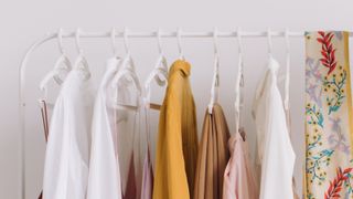 Clothes Hanging In Rack At Home - stock photo