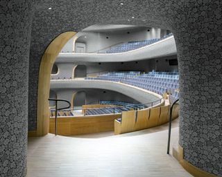 Approaching the Opera Hall through the building’s corridors, the double curved skin hints to the spectacular interior inside.