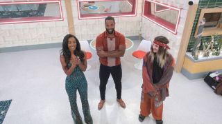 Taylor, Monte, and Turner staring at the memory wall in Big Brother