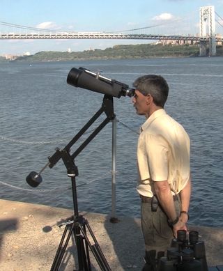 A sturdy tripod and a conterweighted arm make for hours of easy wiggle-free observing, even with massive binoculars. Note that the author (pictured) is not touching the binoculars or tripod. 