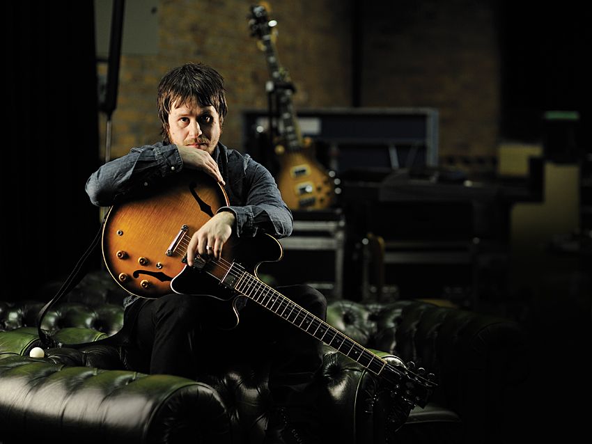 The Elbow guitarist cradles his beloved Gibson ES-335